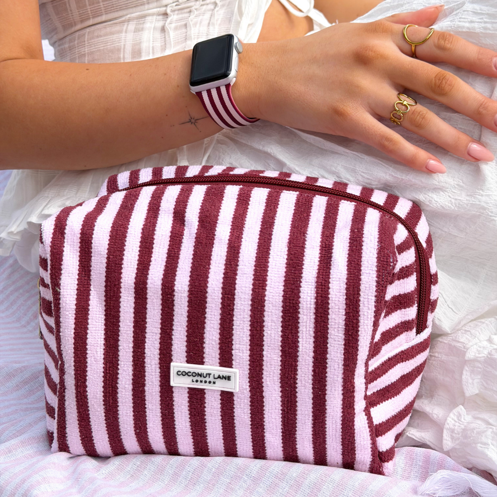 Girl sat on sun bed on holiday with her BlushBerry Scallop Stripes Towel Makeup Bag