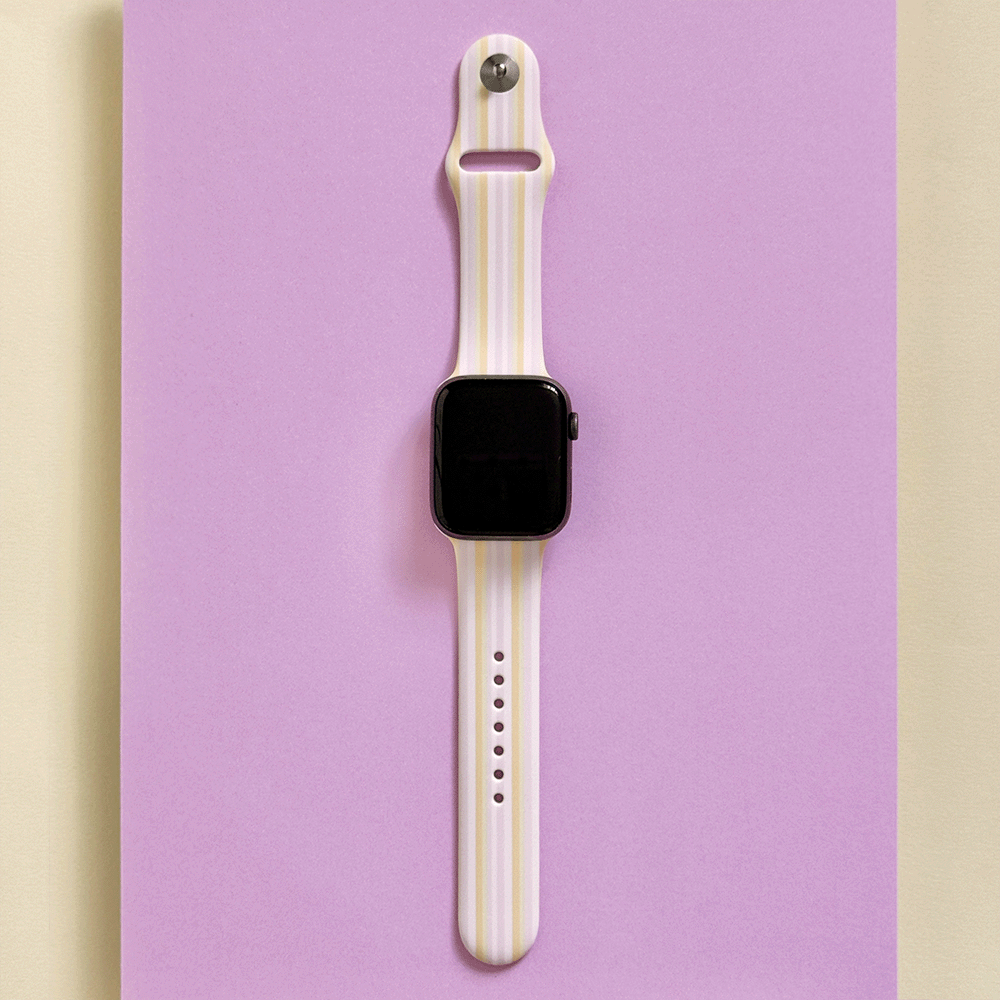 Apple Watch with a pastel stripe band on a purple background