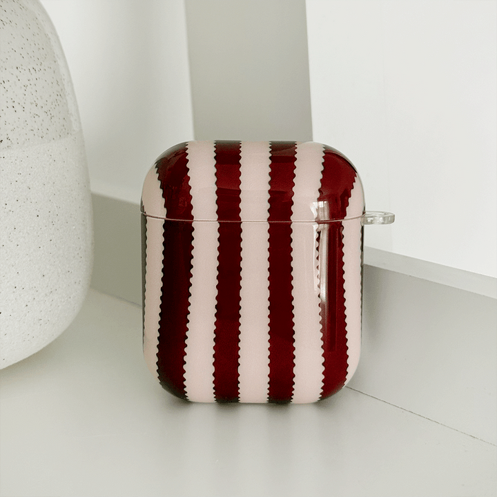 Burgundy and light pink striped protective case for Apple AirPods.