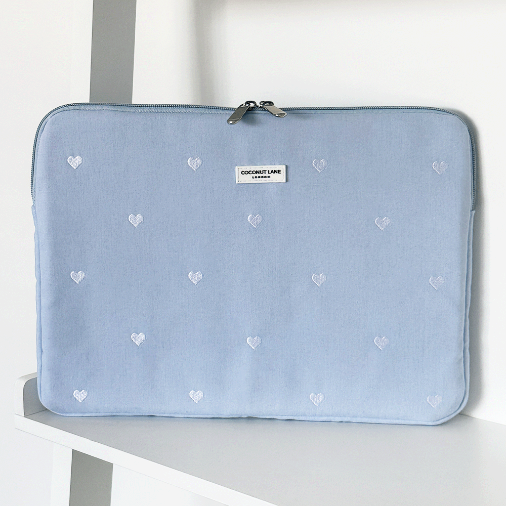 Blue fabric Laptop Sleeve with embroidered heart design.