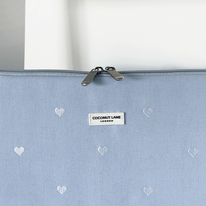 Blue fabric Laptop Sleeve with embroidered heart design.