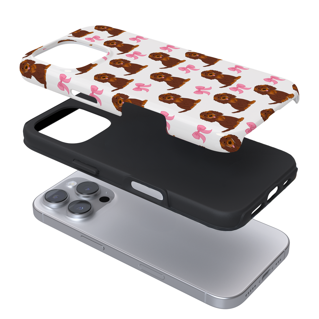 Expanded view of a phone case with a dog and bow pattern on a white background