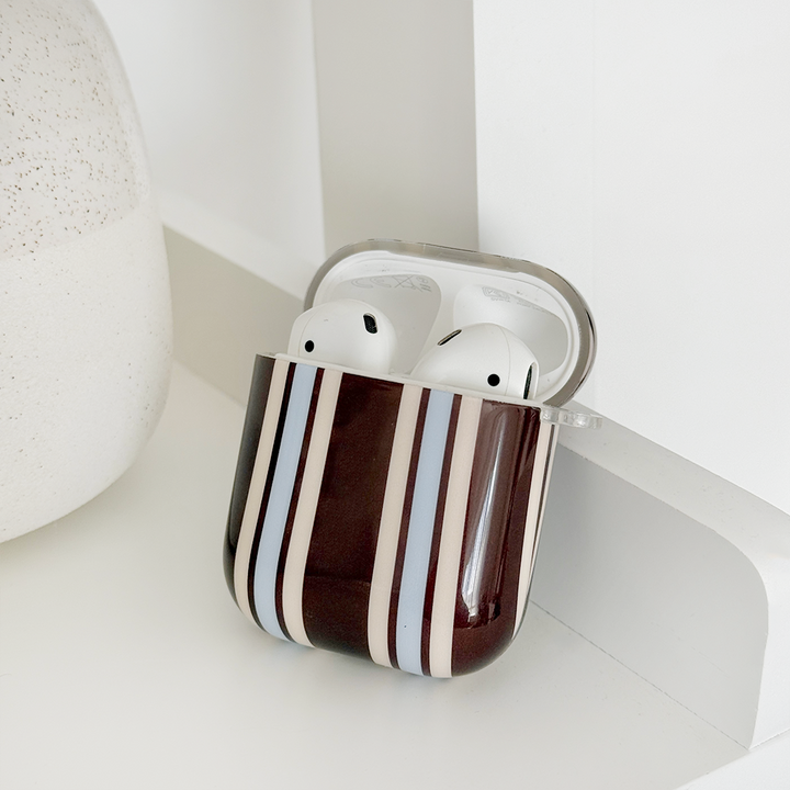 Showing the inside of brown, white and blue striped AirPods Case.