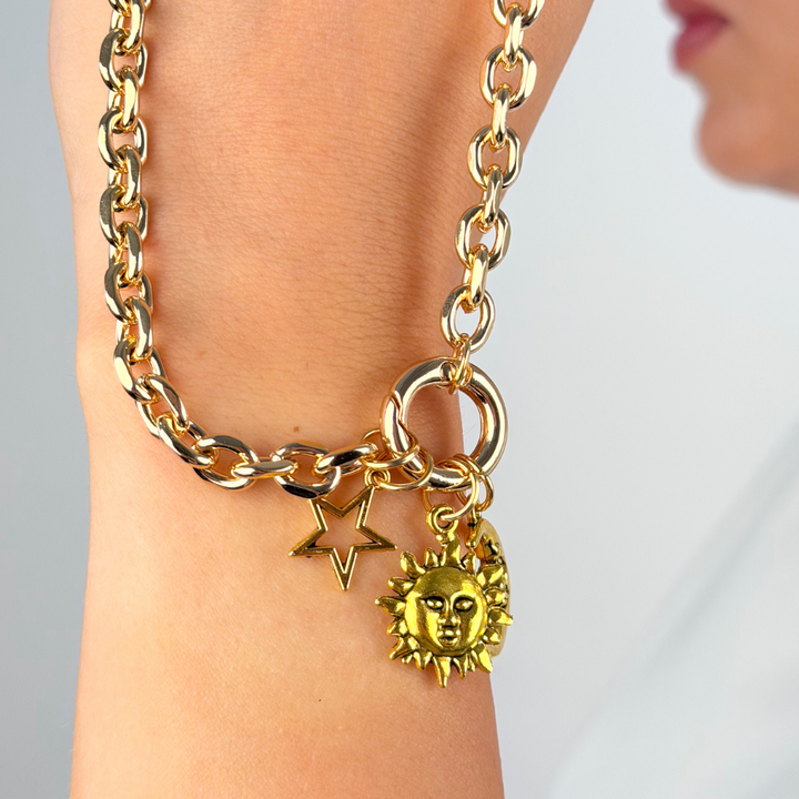 Close up image of the charm bar chain resting on girls wrist showing chunky o ring