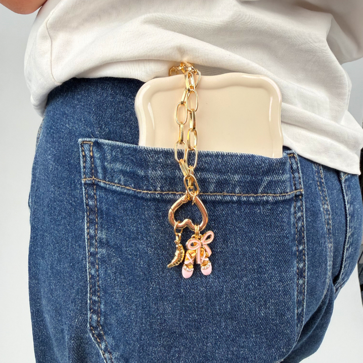 Paperclip Heart Ring Charm Bar Chain shown in blue denim jeans attached to phone case