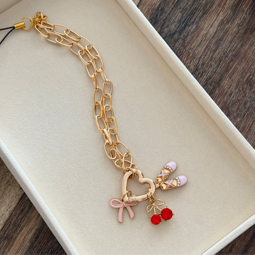 Gold paperclip chain phone strap with 3 charms