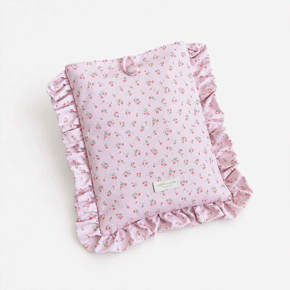 Pink floral patterned Book Sleeve with ruffled trim.