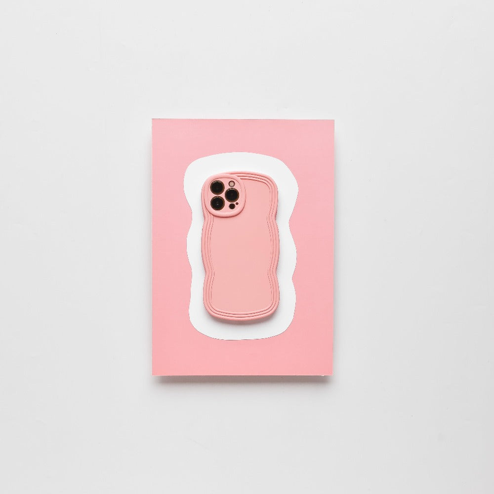 A NAKD Curvy Phone Case - Strawberry from Coconut Lane, featuring four camera cutouts, is showcased on a light pink background with a white border around the case shape, creating a layered effect. The clean, minimalistic design highlights the matte finish and contours while offering highly protective phone cases.
