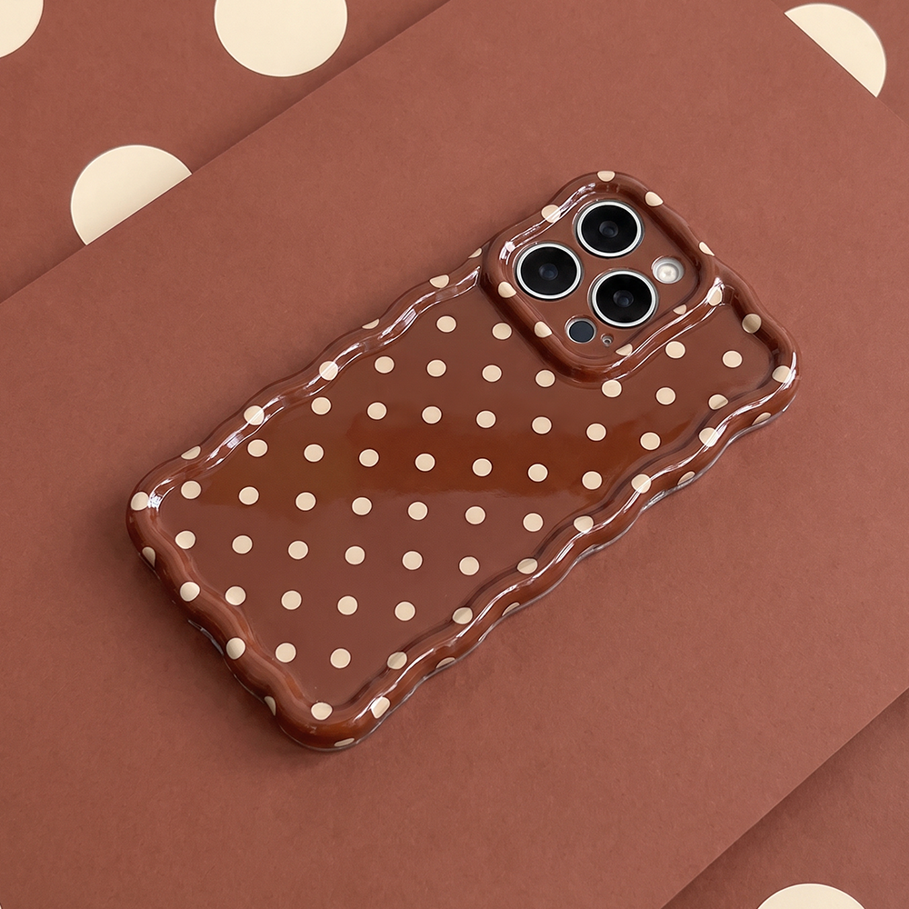 Glossy brown phone case with small cream polka dots and a wavy edge.