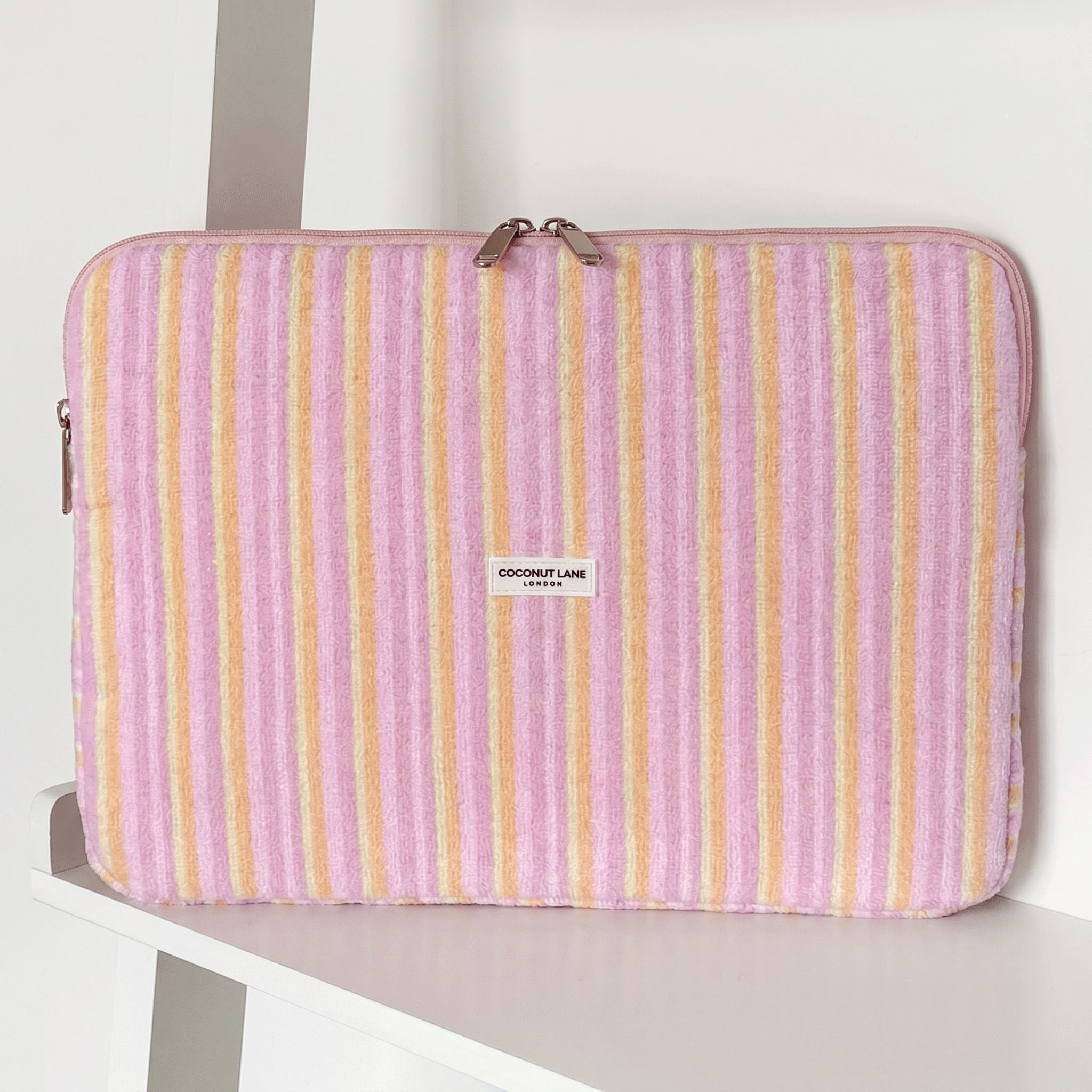 Pink, orange and yellow striped Laptop Sleeve, with silver zip and Coconut Lane Logo.