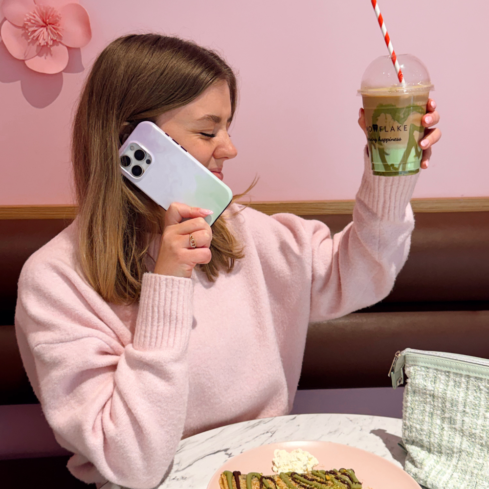 Girl holding matcha in the air whilst holding the Lavender Tough Phone Case