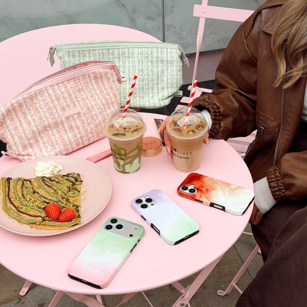 Group flatlay picture on a pink table of Matcha Tough Phone Cases