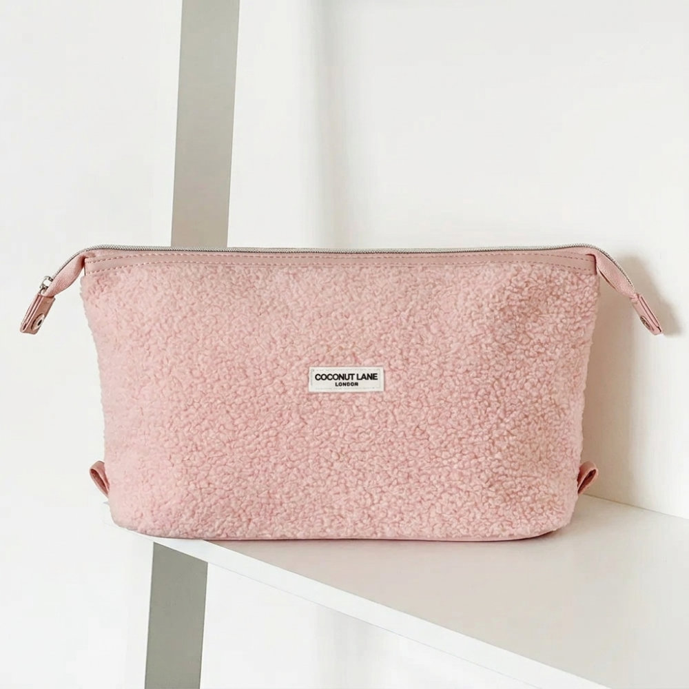 Pink textured boucle bag with silver zip and Coconut Lane logo.