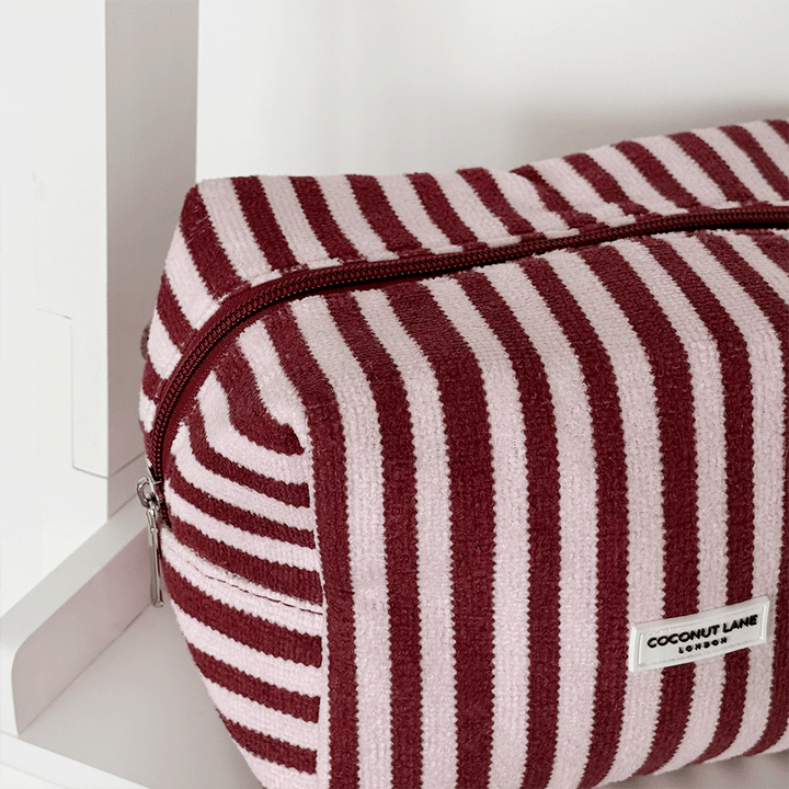 Burgundy and light pink striped Makeup Bag, silver zip and Coconut Lane logo badge.