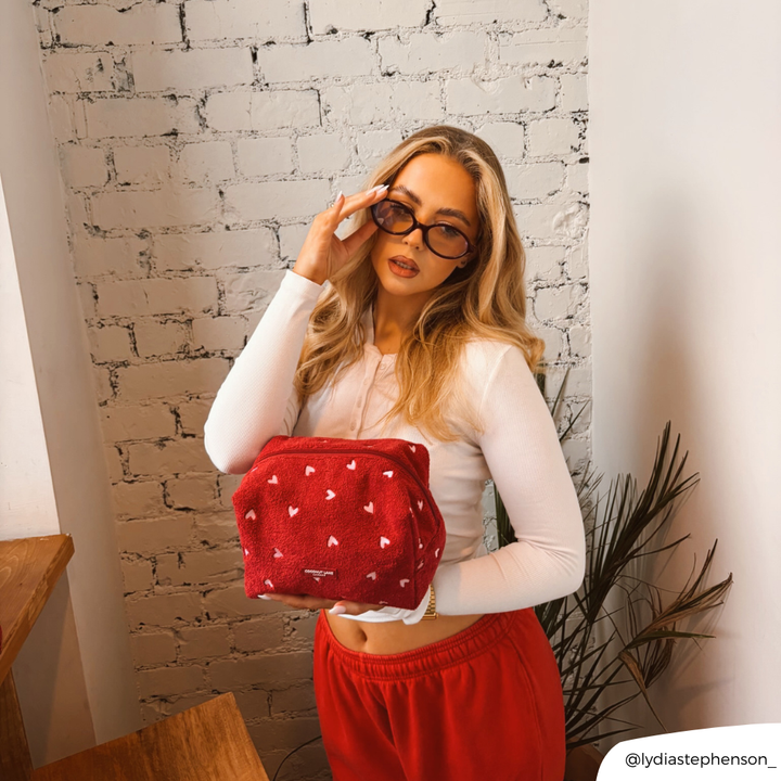 Girl holding her glasses posing with Mulberry Hearts Towel Makeup Bag