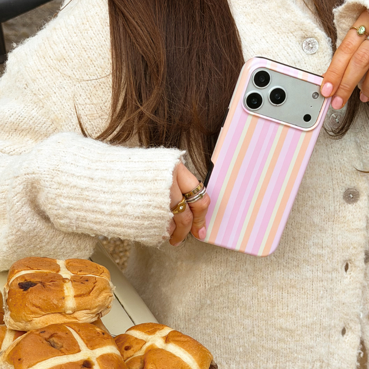 Girl holding pastel stripes phone case close up
