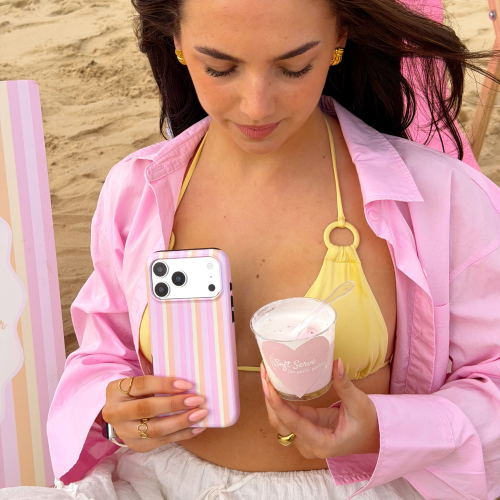 Girl on the beach holding her ice cream with the pastel stripes tough phone case