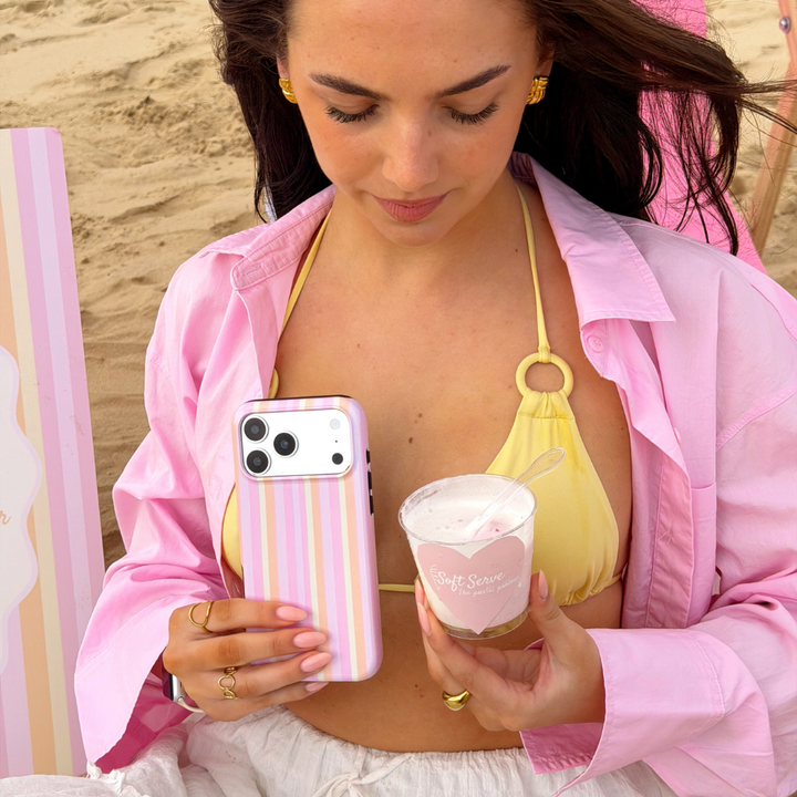 Girl on the beach holding her ice cream with the pastel stripes tough phone case