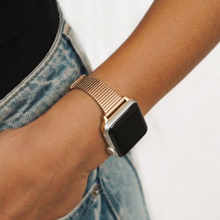 Girls hand in blue jeans pocket wearing her Slim Fine Line Watch Strap in Rose Gold