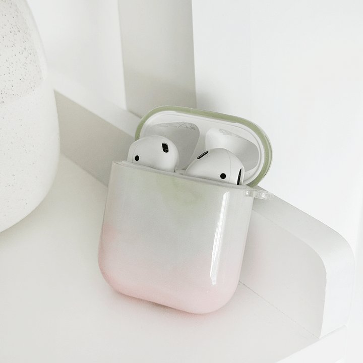 Green and pink ombre effect AirPods Case. Colour fades from green at the top into white, into pink. 