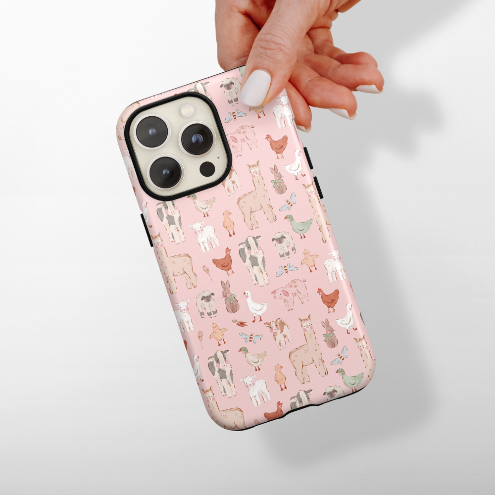 Phone case with animal pattern held by a hand on a light gray background