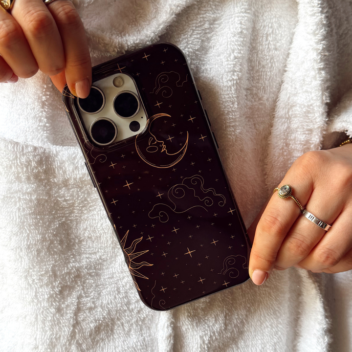 Girl in white dressing gown holding tough celestial phone case close up image