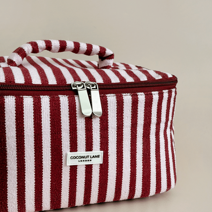 Burgundy and light pink striped Vanity Case, with handle, silver zip and Coconut Lane logo badge.