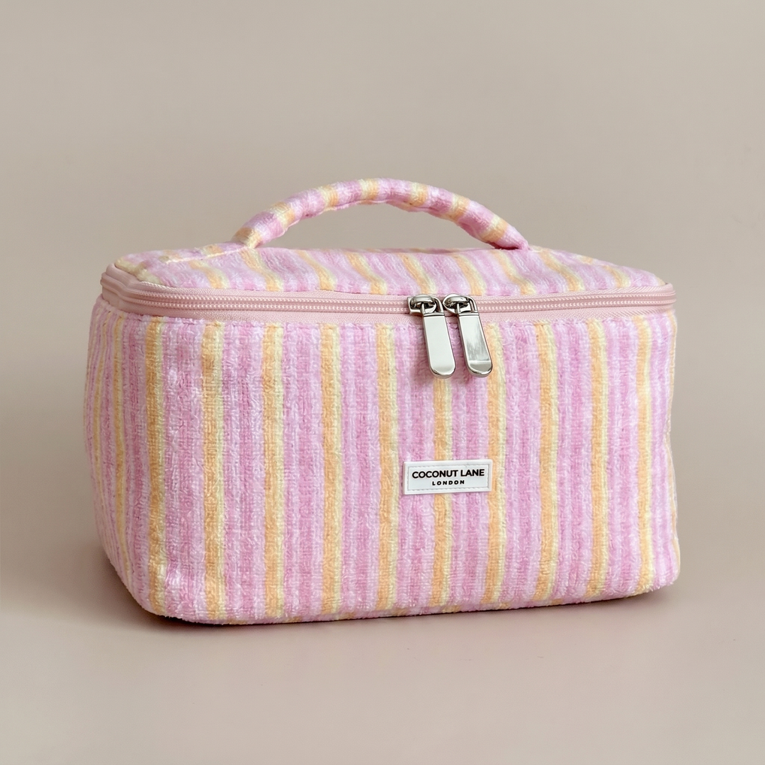 Pink, orange and yellow striped Vanity Bag in towel fabric with Coconut Lane logo.