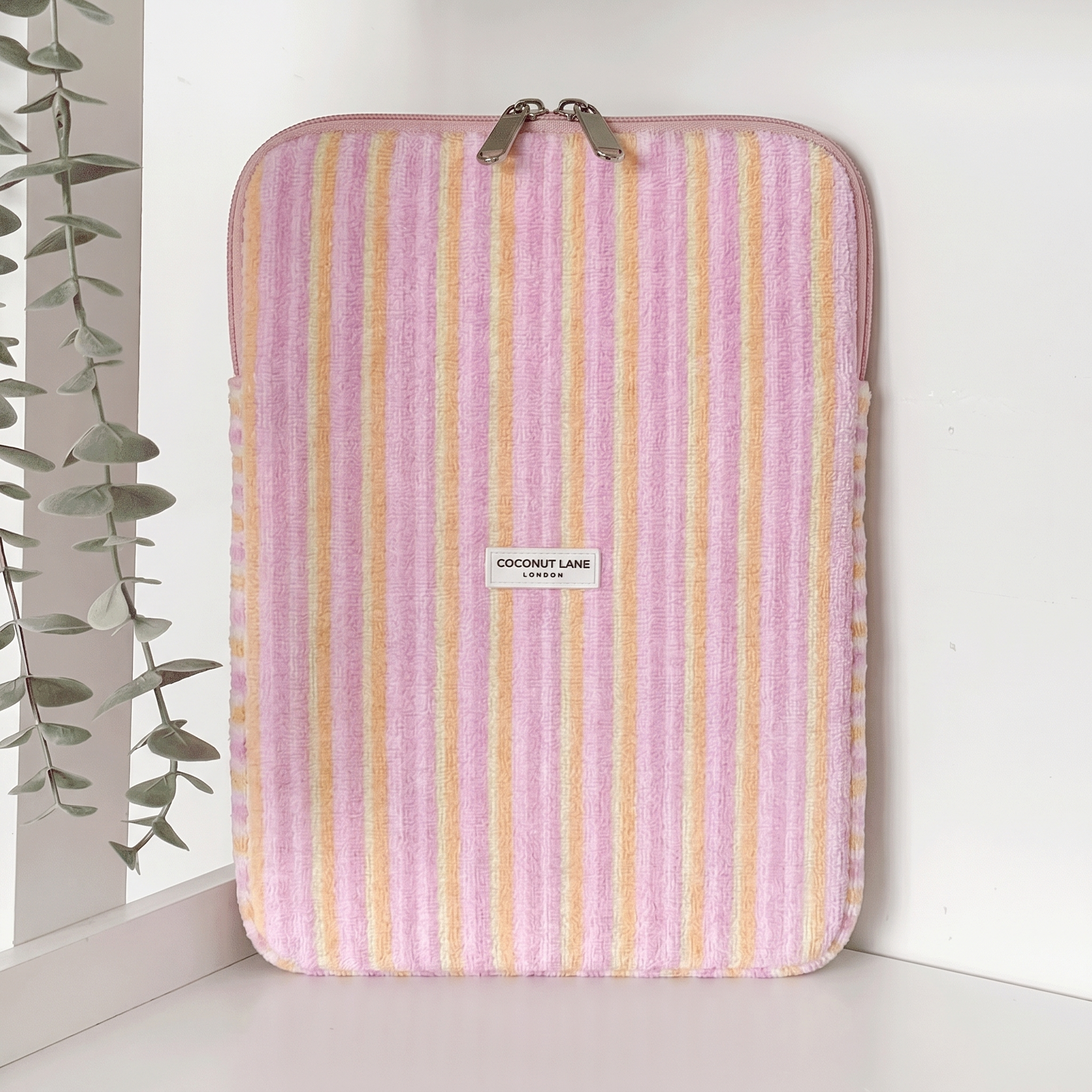 Pink, orange and yellow striped iPad Sleeve, with silver zip and Coconut Lane Logo.