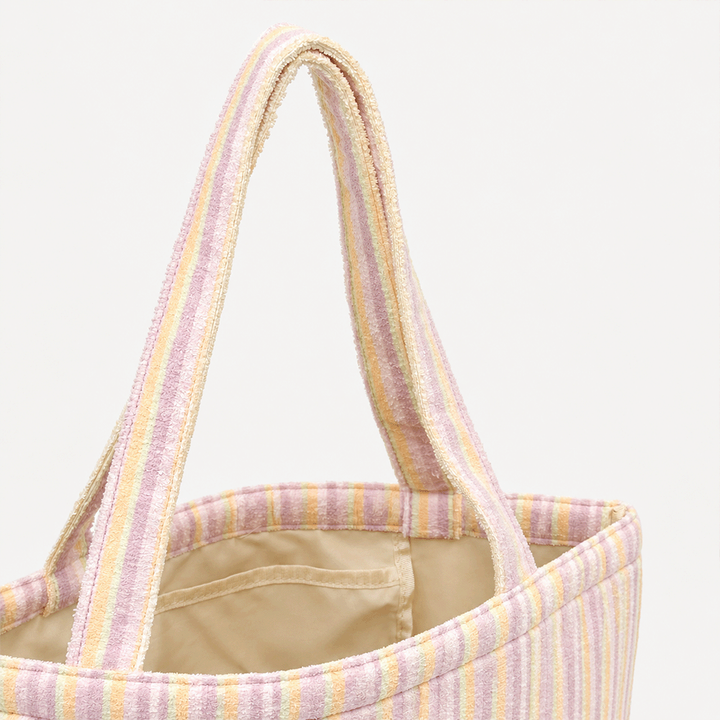 Pastel striped tote bag with two handles and a beige lining.