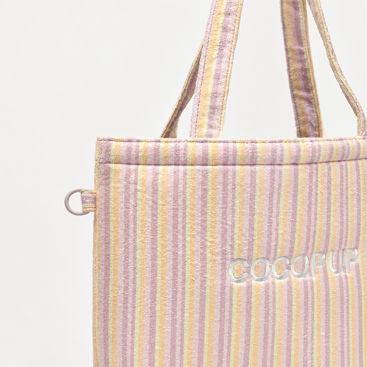 Pastel striped tote bag with a towel-like texture, shown from the side.