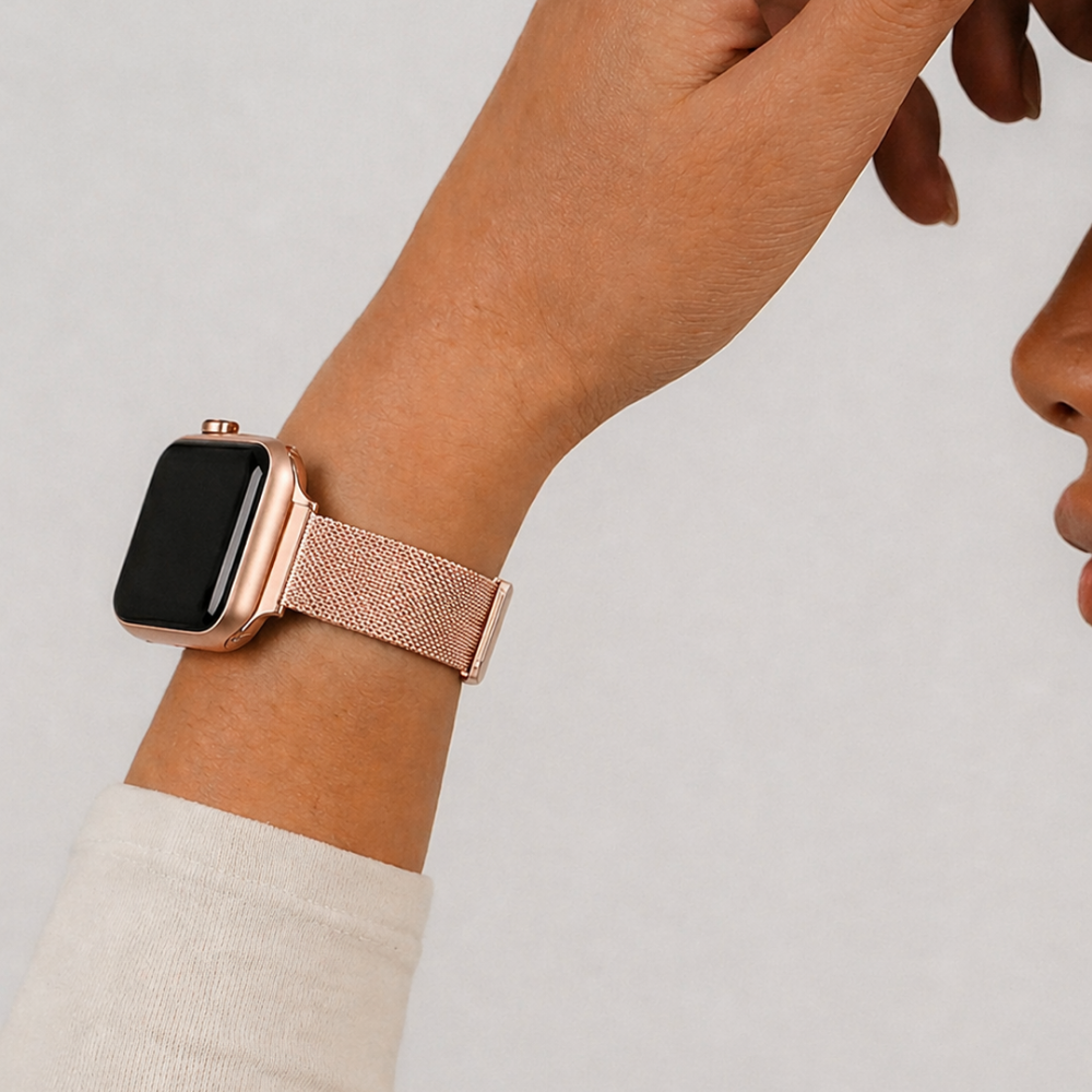 Studio picture of the rose gold milanese watch strap on a girls wrist