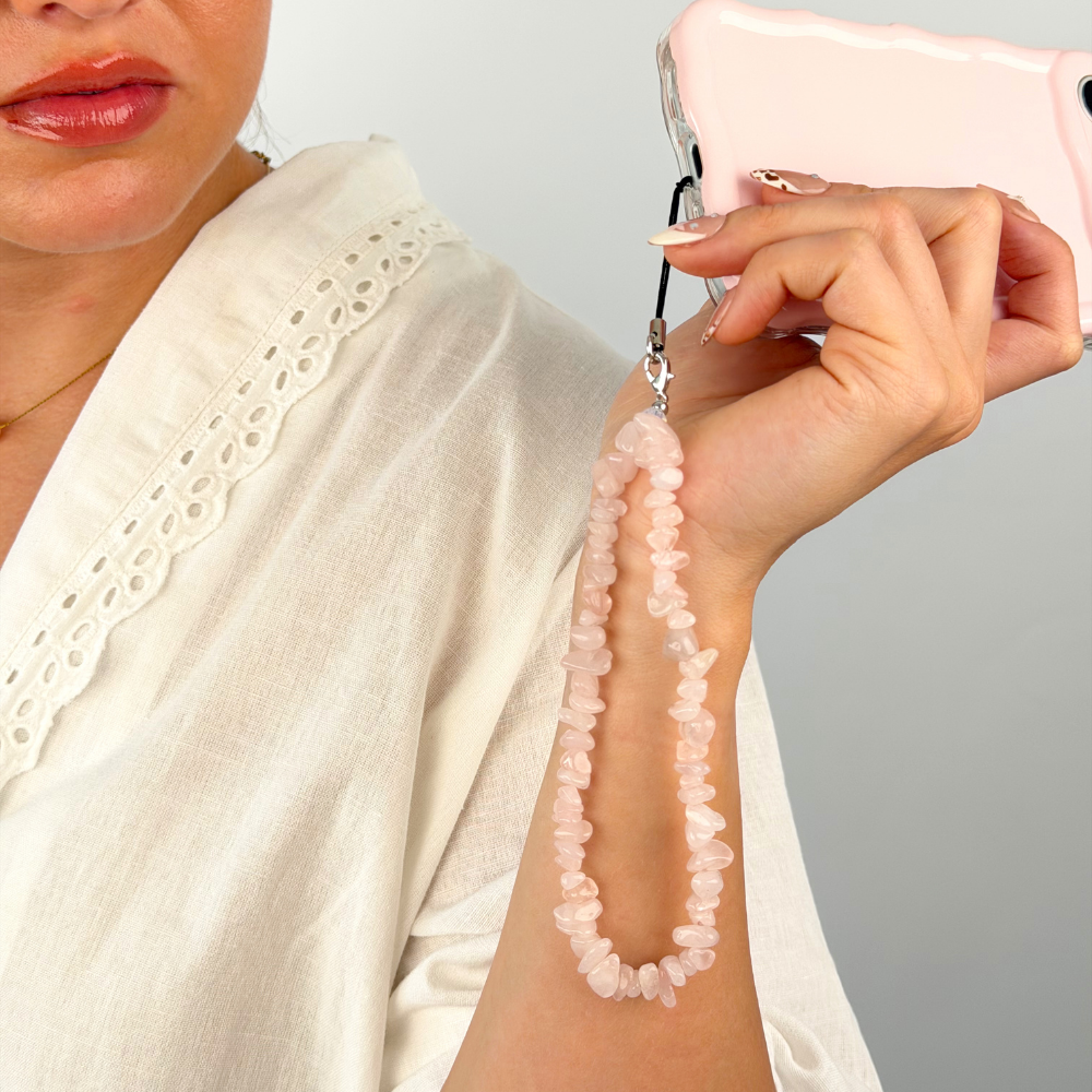 Image of rose quartz phone strap in studio shoot
