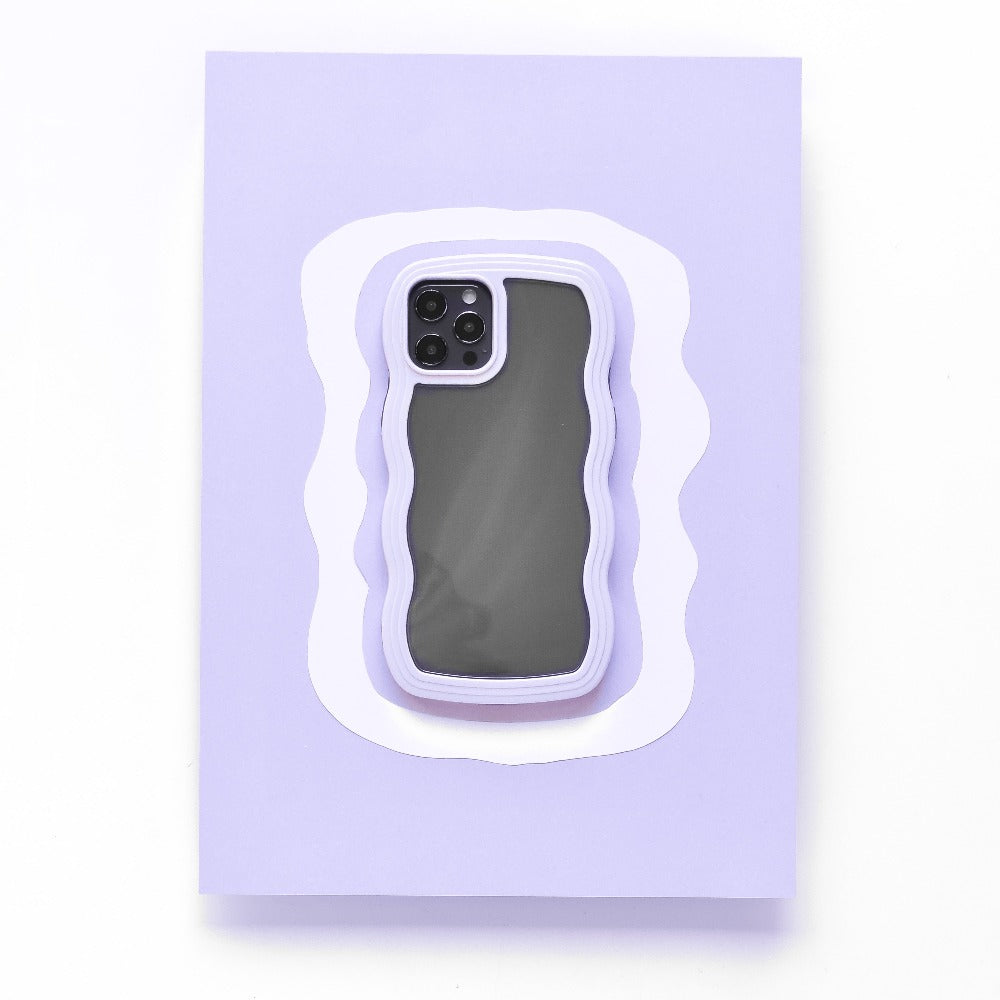 A black iPhone 15 with a highly protective Lilac Curvy Phone Case from Coconut Lane is placed on a light purple and white layered background. The case's modern, abstract design contrasts with the rectangular shape of the phone, while the camera lenses remain visible in the top left corner.
